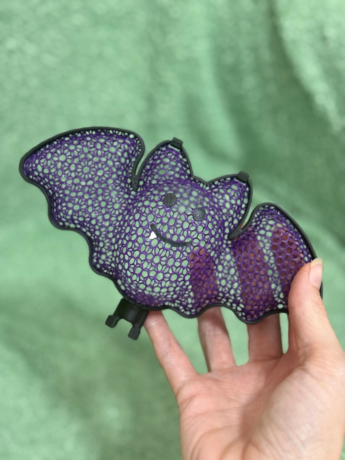 Purple 3D printed Halloween bat treat holder filled with Celebration chocolates